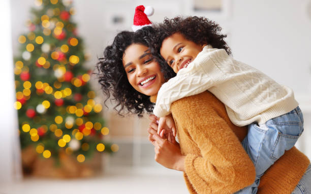 istock Happy mother playing with son on Christmas day 1288386147