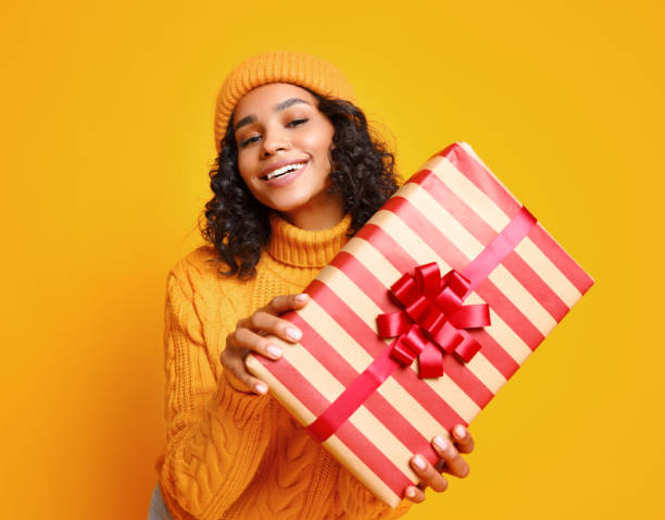 istock Glad young ethnic female with Christmas gift 1288386188