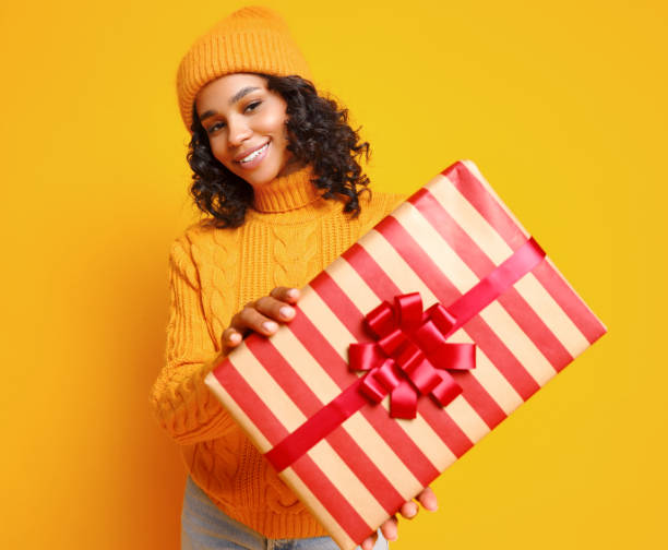 istock Glad young ethnic female with Christmas gift 1288386219
