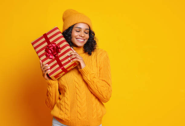 istock Glad young ethnic female with Christmas gift 1288386248