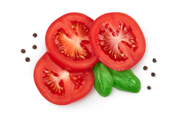 istock Tomato slices with basil and peppercorns isolated on white background. Clipping path . Top view. Flat lay 1288386503