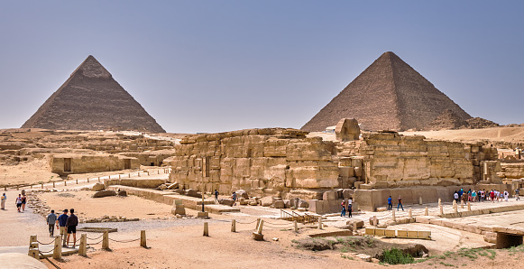 Giza Plateau, Cairo / Egypt - May 25, 2019: Tourists visiting the Giza Plateau with the Great Sphinx and the Giza pyramid complex in Cairo, Egypt