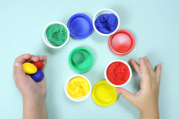 istock colored mass for modeling for children's creativity, molded green ball in a child's hand, selective focus 1288387921