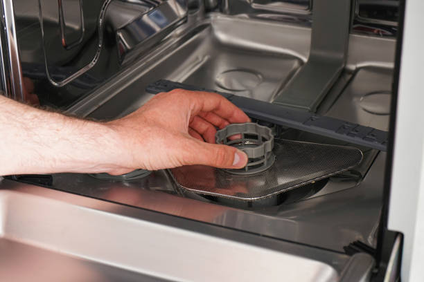 istock Cleans the filter in the dishwasher. Home appliance maintenance. 1288389322