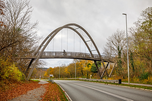 Frederikssund, Zealand, Denmark, November 19, 2020. Pedestrian and cycling-bridge over a road with one man crossing