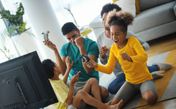 istock Family playing video games at home. 1288390866