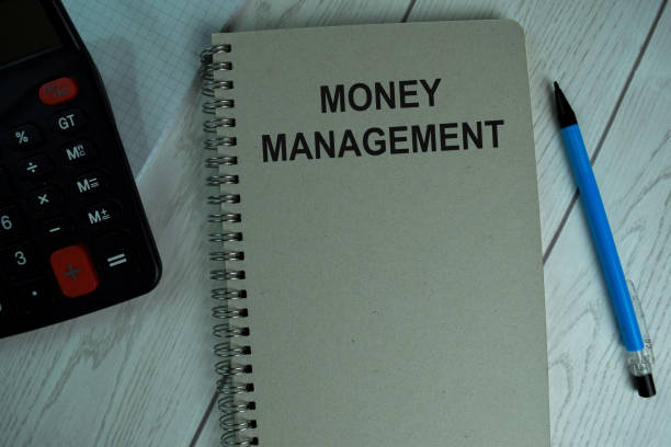 istock Money Management write on a book isolated on office desk. 1288392418