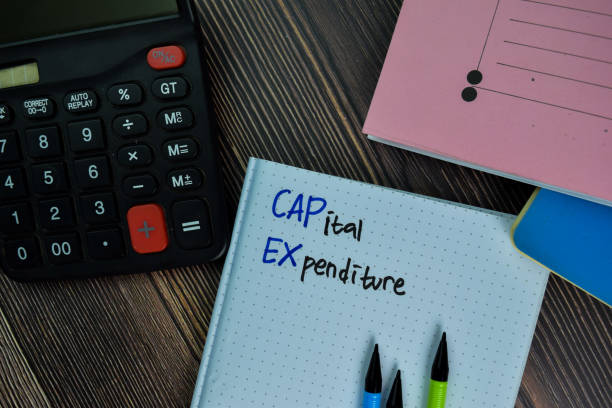 istock Capital Expenditure write on a book isolated on office desk. 1288393113