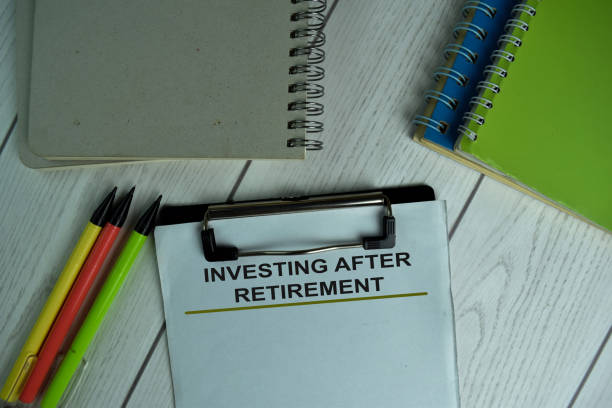 istock Investing After Retirement write on a paperwork isolated on wooden table. 1288393213