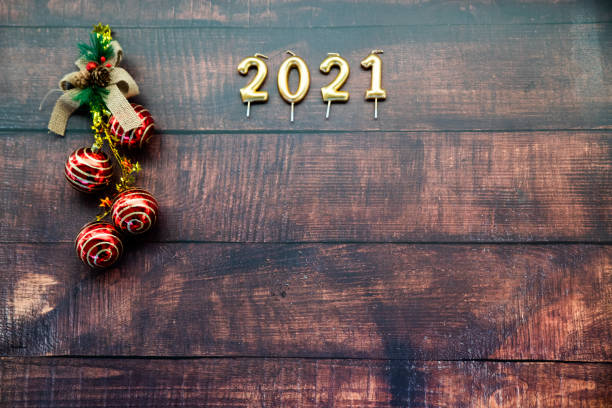 istock Year 2021 on horizontal dark wood background 1288393230