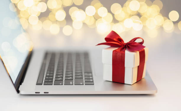 istock Gift on laptop at office desk, holidays, celebration concept 1288393345