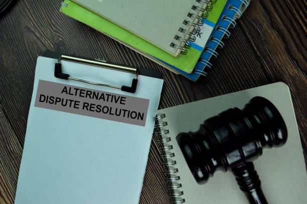 istock Alternative Dispute Resolution write on a paperwork isolated on wooden table. 1288393466