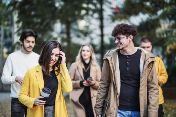 istock Happy college students walking together on campus 1288394124