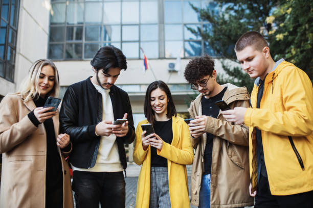 istock Young people, students, looking at smartphones 1288395921