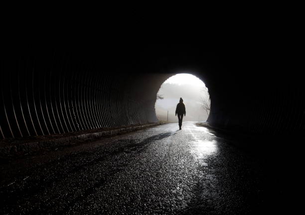 light at the end of tunnel lonely silhouette walking trough darkness, depression mental illness photos stock pictures, royalty-free photos & images