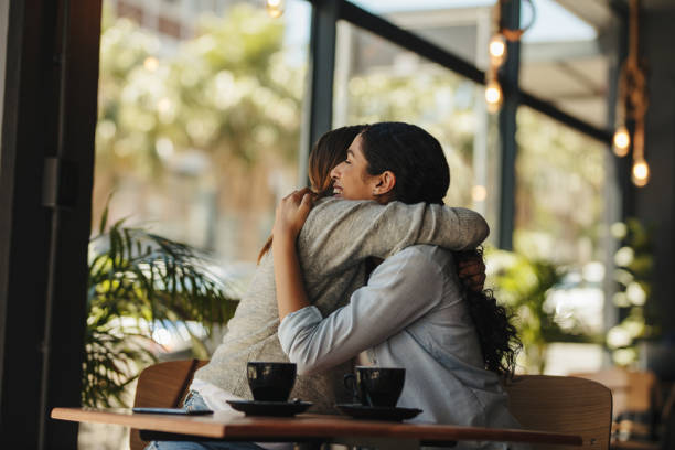 istock Friends greeting each other with a hug 1288396019