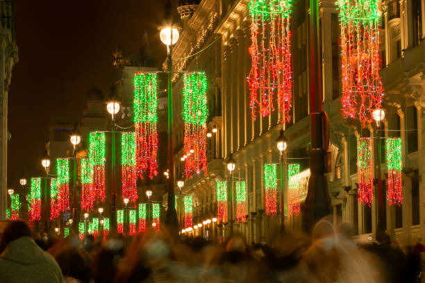 Christmas illumination of Alcala street in Madrid, Spain. People walking at night in this historic street with Covid19 masks. November 28, 2020. long exposure winter crowd blurred motion stock pictures, royalty-free photos & images