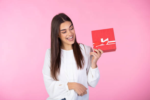 istock Smiling woman hold red gift box. 1288400986
