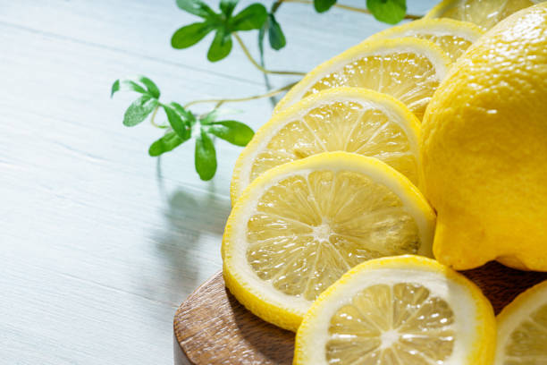 istock Sliced lemon fruit isolated on wooden table 1288404189