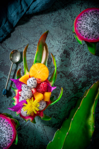 istock Dragon fruit Pithaya fruit salad half cut with spheres on moody green 1288406363