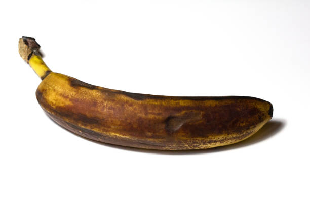 istock Ugly banana on a white background. Rotten fruit. Banana close-up isolate. 1288406448