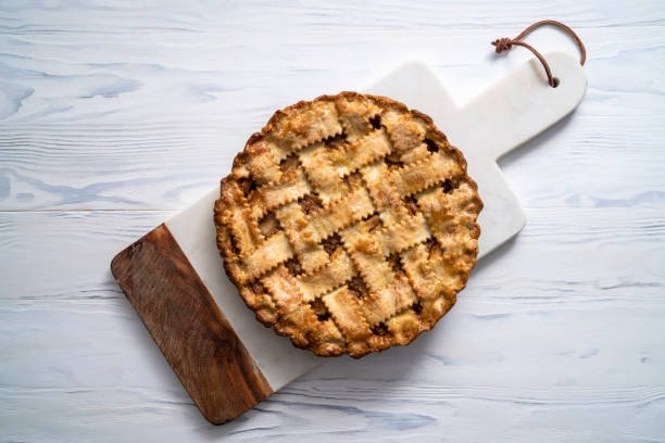istock American apple pie on cutting board on white wooden table 1288406520