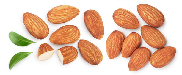 istock Almonds nuts with leaves isolated on white background with clipping path and full depth of field. Top view. Flat lay. 1288407133