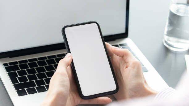 istock Close up young woman holding smartphone with mock up screen. 1288409492