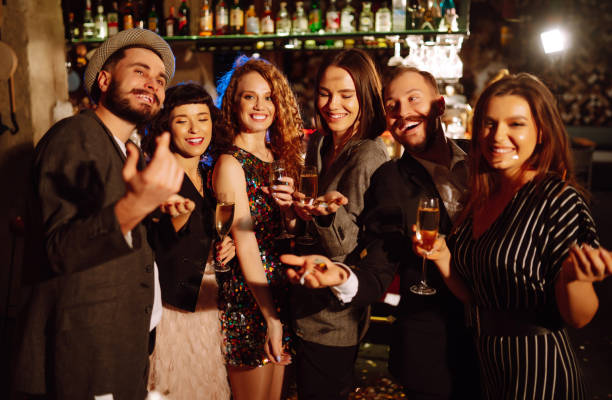 istock Happy friends throwing confetti and jumping while enjoying party. 1288409655