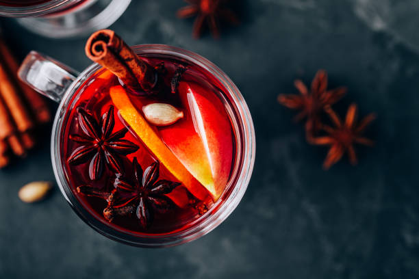 istock Christmas Mulled Wine with spices and fruits on a dark background, copy space. 1288410295