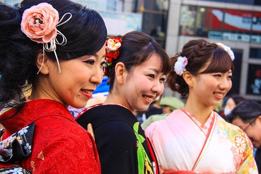 Japanese women wearing kimono smiling and posing in front of camera during Toka Ebisu Festival in Osaka, Japan