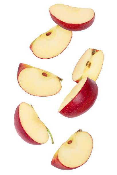 istock falling Red apple slices isolated on white background, 1288413263
