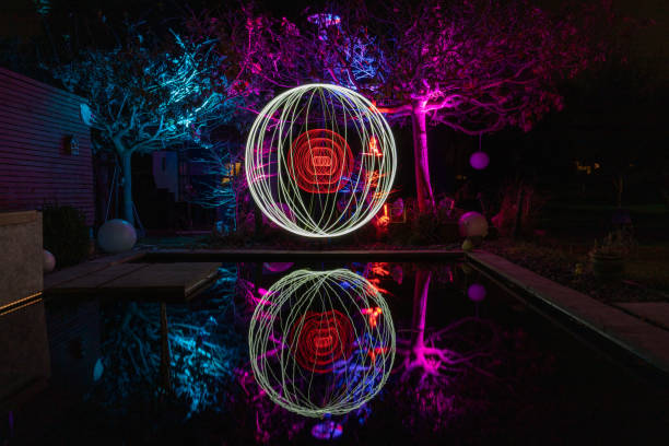 istock Light painting with colorfully illuminated trees 1288415572