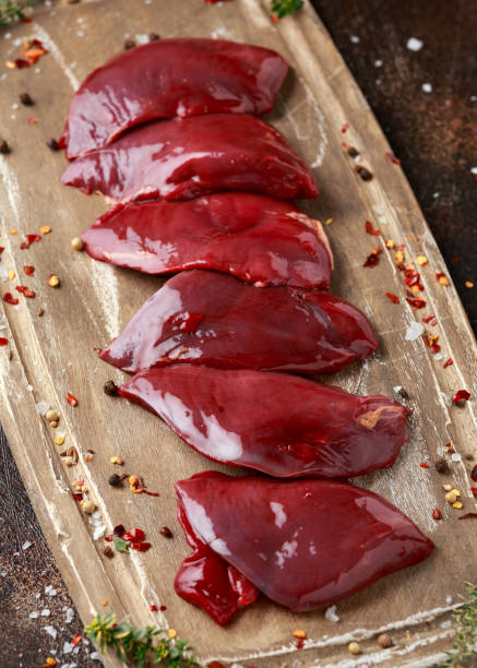 pigeon breast fillets ready to cook with seasoning mix on wooden board pigeon breast fillets ready to cook with seasoning mix on wooden board. squab pigeon meat photos stock pictures, royalty-free photos & images