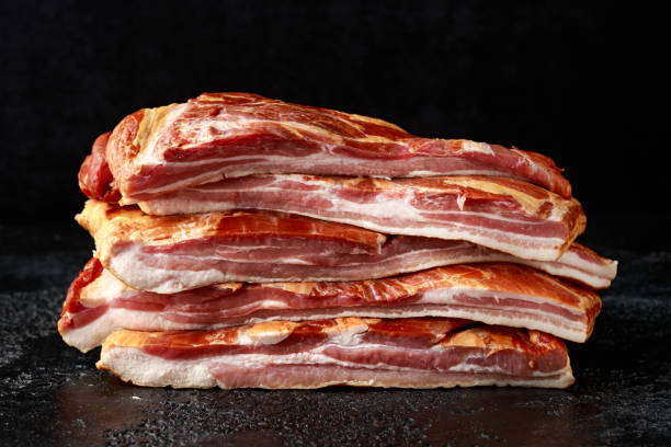 stripy cured pork side bacon pancetta smoked on wood chip - pancetta imagens e fotografias de stock