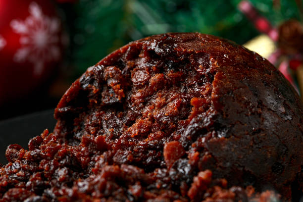 istock Christmas pudding with decoration, gifts, green tree branch on wooden rustic table 1288416244