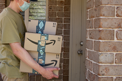 Sydney, Australia - 2020-10-17 Amazon prime boxes and envelopes delivered to a front door of residential building