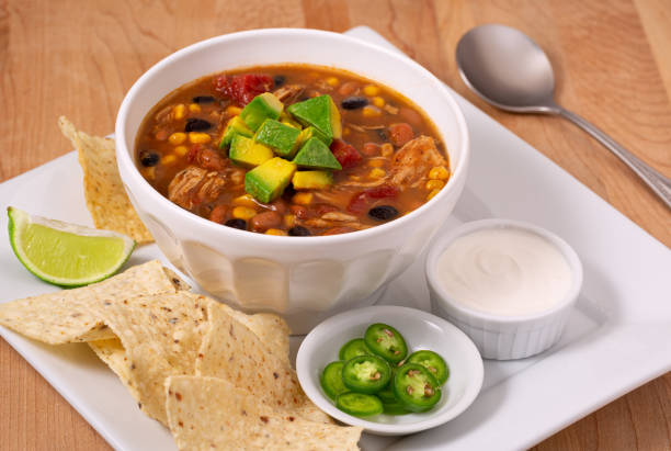 istock Taco chicken soup meal patter with tortilla chips and condiments 1288416335