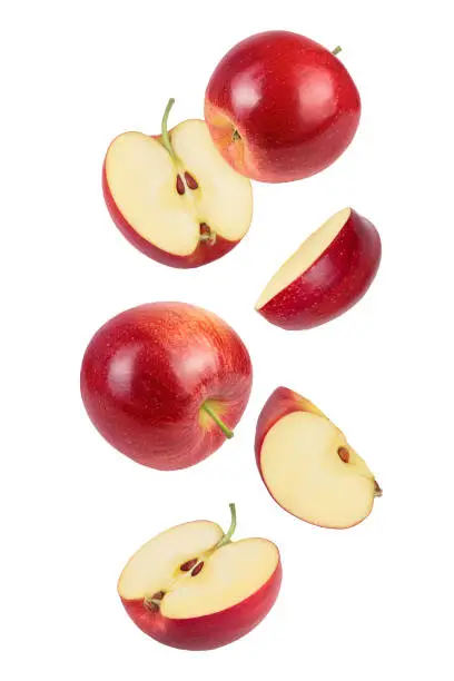 Photo of falling Red apple slices isolated on white background,