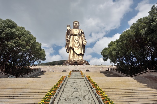 Lampang Province, Thailand. November 21, 2022. Great Buddha or Kamakura Daibutsu statue. Tourists visiting the temple. Famous big Buddha statue inside Wat Phra That Doi Phra Chan temple.