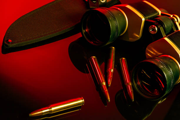 Ammunition money and a pocket knife isolated on red