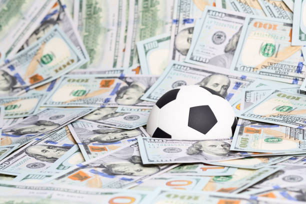 Football (Soccer) ball on the U$100 dollars banknote background.