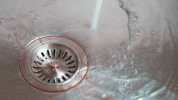istock Metal Sink with Water in Drain 1288420235