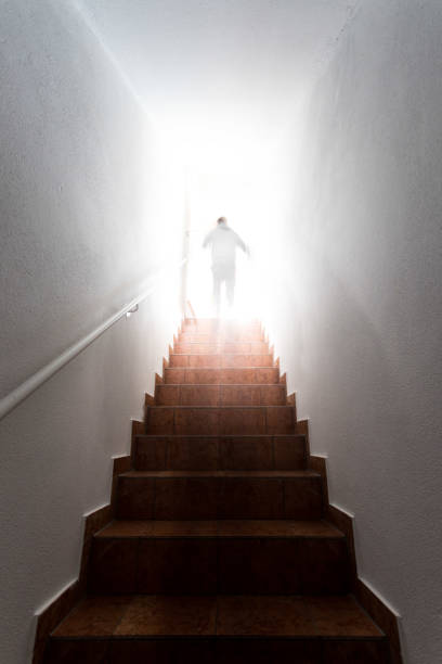 istock Man on basement stairway with railing, bright natural sunlight 1288420360