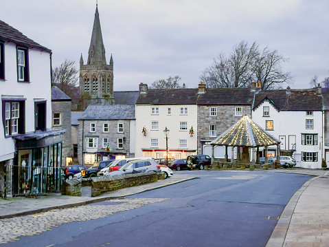Alston Front street at Christmas with lights on the Market Cross.