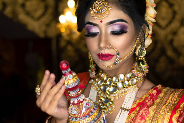 Portrait of very beautiful Indian bride holding traditional wooden sindur or sindoor box in hand, Wedding symbol sindoor box. stock photo