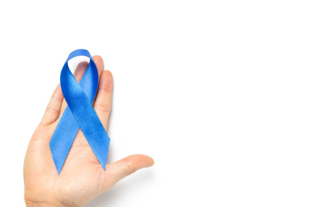 istock Prostate awareness. Blue ribbon in hands isolated on white background. Awareness prostate cancer of men health in November. Healthcare, International men, Father day. 1288424705