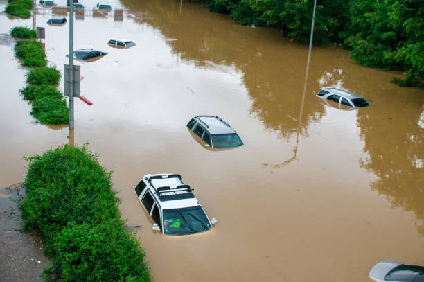 istock flooded car on the road after downpour 1288425920