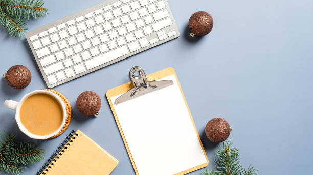 istock Home office desk with Christmas decorations, coffee cup, keyboard, clipboard. Flat lay, top view. Christmas workspace. Hygge, nordic, minimal style. 1288427318