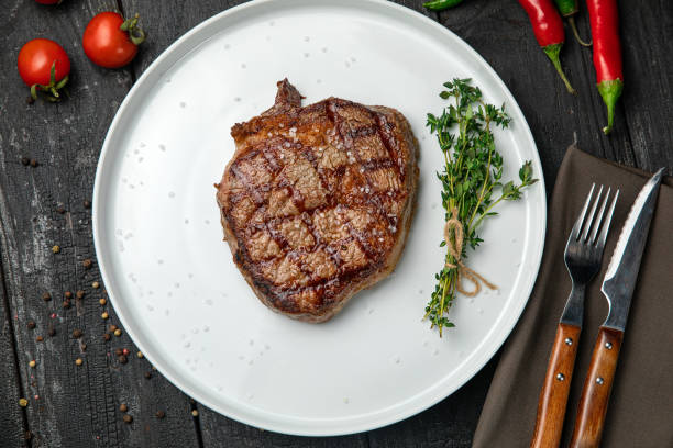 istock grilled steak on a white round plate. 1288427560